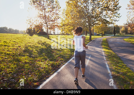 Donna in corsa nel parco, sfondo fitness Foto Stock