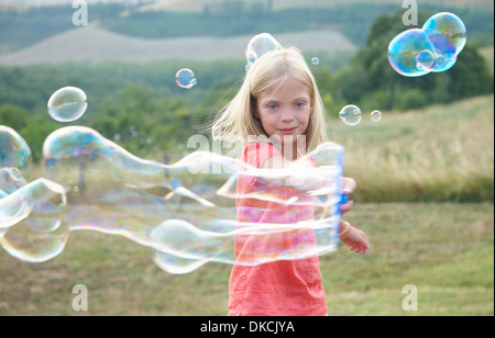 Ragazza che gioca con le bolle di sapone Foto Stock