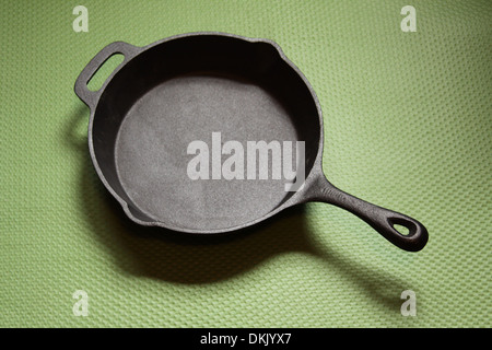 Scrigno padella di ferro su un tappeto verde Foto Stock