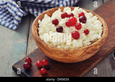 Formaggio con mirtilli freschi nella ciotola di legno closeup Foto Stock