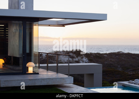 Casa moderna con vista sull'oceano al tramonto Foto Stock