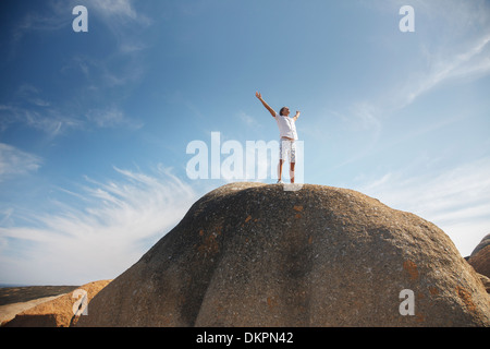 Uomo in piedi sulla parte superiore di formazione di roccia Foto Stock