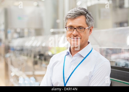 Imprenditore sorridente in fabbrica Foto Stock