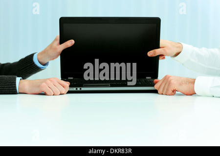 Closeup image of a business hands holding a laptop blank screen Foto Stock