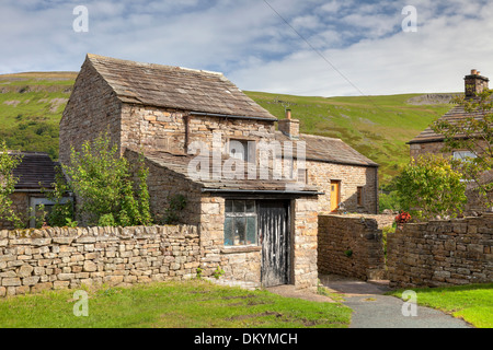 Cottage in pietra con fienile in Yorkshire Dales villaggio di Muker, Swaledale, Inghilterra. Foto Stock