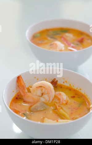Thai piccante e speziato zuppa di pesce con gamberi e vegetale in ciotola bianco Foto Stock