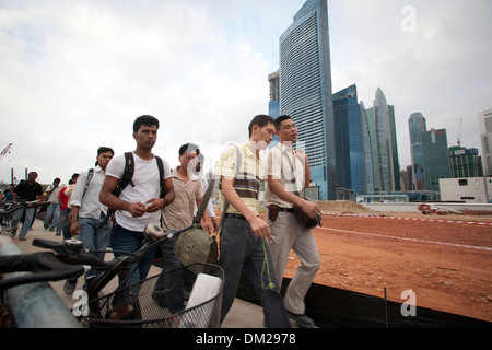 I lavoratori migranti prima del loro spostamento sui siti di costruzione nella Marina Bay Sands area di Singapore Foto Stock