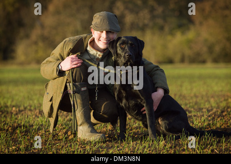 Un Nero Labrador Retriever con il suo proprietario su un fagiano sparare in Inghilterra Foto Stock