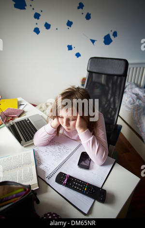 Annoiato ragazza in camera da letto utilizzando Laptop Foto Stock