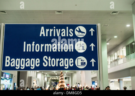 Segno di direzione per gli arrivi, informazioni e il deposito bagagli in aeroporto di Manila Foto Stock