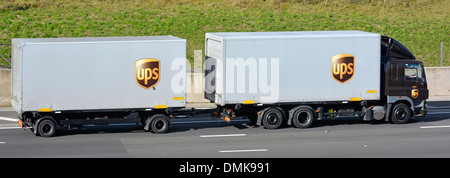Catena di fornitura trasporto logistico da United Parcel Service pacchi UPS il logo del marchio su autocarro traino del rimorchio guidando lungo Inglese Regno Unito autostrada Foto Stock