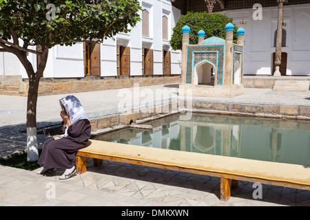 Signora pregando, Bakhauddin Naqshband complessa, anche noto come memoriale della Baha annuncio Naqshbandi Din, Bukhara, Uzbekistan Foto Stock