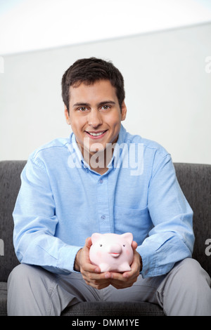 Imprenditore Azienda Piggybank Foto Stock