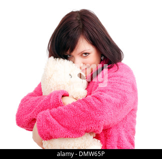 Giovane donna in rosa accappatoio coccole con il suo orsacchiotto Foto Stock