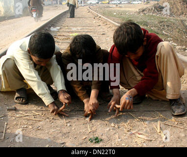 Peshawar. Xviii Dicembre, 2013. Profugo afgano ragazzi giocare su binari ferroviari sulla periferia del nord-ovest del Pakistan Peshawar a Dic. 18, 2013. Il 18 dicembre è il giorno in cui la comunità internazionale riconosce i diritti dei migranti di tutto il mondo. La giornata è stata ufficialmente designata come la Giornata Internazionale dei Migranti dalle Nazioni Unite nel 2000. © Ahmad Sidique/Xinhua/Alamy Live News Foto Stock