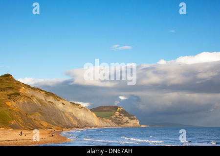 Vista di Golden Cap su Jurassic Coast, Dorset, Inghilterra visto dal Charmouth con i cacciatori di fossili sulla spiaggia. Foto Stock