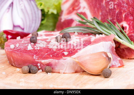 Carne cruda, spezie e verdure isolato su bianco Foto Stock