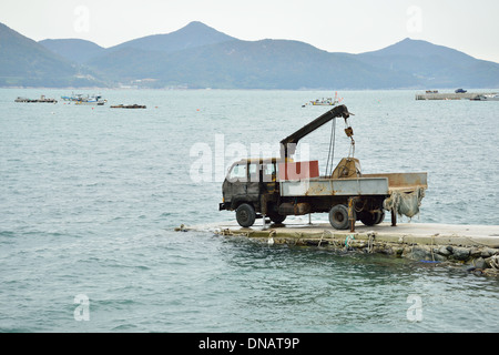 Un vecchio arrugginito carrello su strada al mare Foto Stock