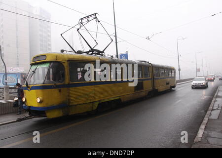 Sarajevo, Bosnia ed Erzegovina. 23 Dic, 2013. Una fermata del tram si trova a vedere la guida su una strada a Sarajevo, nella capitale della Bosnia ed Erzegovina, a Dic. 23, 2013. Sarajevo ha emesso un allarme giallo per inquinamento atmosferico lunedì. Credito: Haris Memija/Xinhua/Alamy Live News Foto Stock