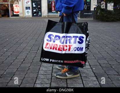 a customer carrying a sports direct shopping bag Foto Stock