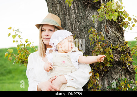 Ritratto di Madre e figlia dal tronco di albero, Mannheim, Baden-Württemberg, Germania Foto Stock