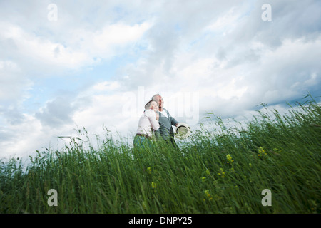 Coppia matura camminando nel campo di erba, Germania Foto Stock
