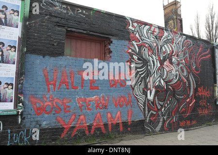 'Tenere lontano il male ' dalla faccia surreale di artista di strada Shaka, dipinta sulla parete del Yaam, Galleria sul lato orientale Strelauer Platz 35, Berlino Foto Stock