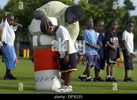 Jul 05, 2006; Delray Beach, FL, Stati Uniti d'America; pulmann Dexter Hazel mostra i suoi giocatori il modo corretto di tenere la testa quando devono affrontare durante la pratica peewee Giovedì, 5 luglio 2006 a Pompey Park in Delray Beach. Peewee è il più giovane e leggero tra le quattro divisioni del youth football league a Pompey. Credito: foto di Chris Matula/Palm Beach post/ZUMA premere. (©) Copyright 2006 Foto Stock