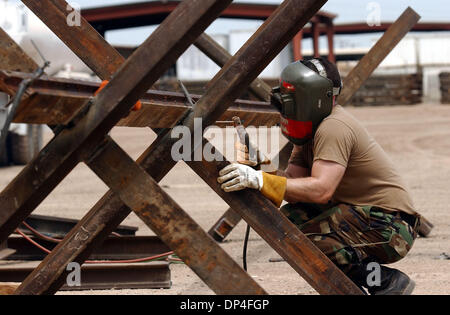 Oct 26, 2006; San Diego, CA, Stati Uniti d'America; il Presidente Bush ha firmato una legge che autorizza giovedì 700 miglia di nuove recinzioni lungo gli Stati Uniti-Messico frontiera, sperando di dare ai candidati Repubblicani un pre-piattaforma di elezione per affermare che sono difficili in materia di immigrazione illegale. Nella foto: sotto un grado 103 El Centro California sun, California Guardia Nazionale Specialista Robert Peralta saldature speciali una recinzione di confine Foto Stock