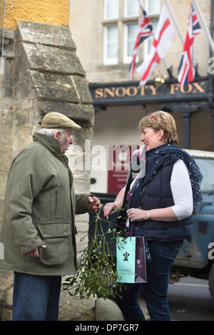 Un uomo vendita di vischio presso la piazza del mercato di Natale a Tetbury, GLOUCESTERSHIRE REGNO UNITO Dec 2013 Foto Stock