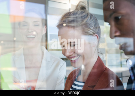 I colleghi ridere, vista attraverso la finestra Foto Stock
