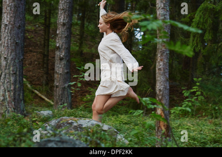 Ragazza adolescente in esecuzione nella foresta Foto Stock