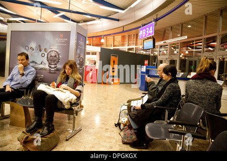 I passeggeri del trasporto aereo in attesa presso il gate a bordo del loro piano, Partenze, aeroporto di Ginevra, in Svizzera Europa Foto Stock