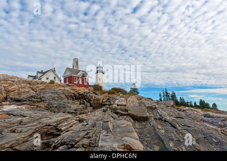 Il faro di Pemaquid Point, Maine con cielo nuvoloso sopra e il massiccio di roccia cenge in primo piano. Foto Stock