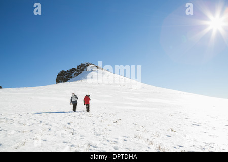Gli sciatori passeggiate sulla neve in una giornata di sole Foto Stock