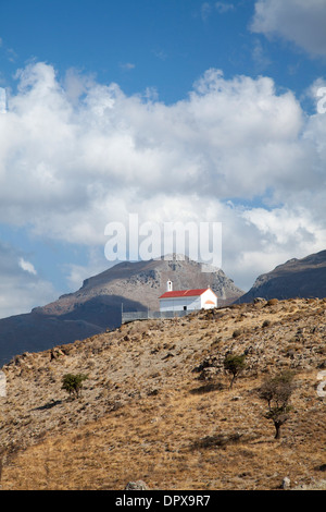 Hill-top chiesa sotto le montagne bianche, vicino a Plakias, Rethymnon distretto, Creta, Grecia. Foto Stock