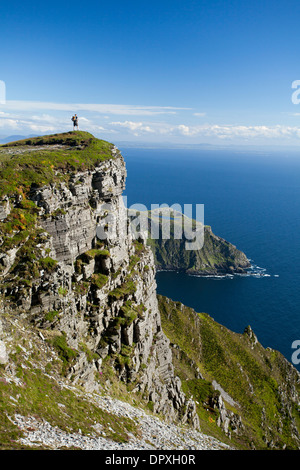 Walker guardando verso Bunglas da vicino al vertice di Slieve League, County Donegal, Irlanda. Foto Stock