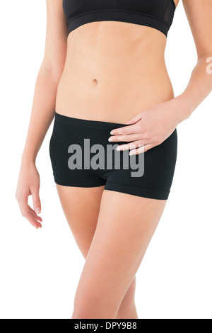 Close-up sezione intermedia di montare una donna in abbigliamento sportivo Foto Stock