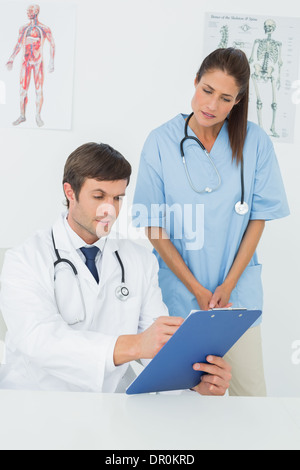 I medici a discutere i report in un ufficio medico Foto Stock