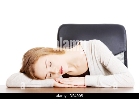 Giovane donna informale studente è dormire su di una scrivania. Isolato su bianco. Foto Stock