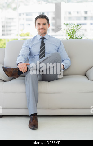 Ritratto di un ben vestito giovane uomo a casa Foto Stock