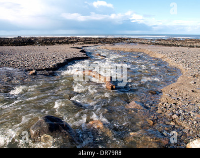 Fiume che scorre verso il basso la spiaggia a bocca Wanson, Widemouth Bay, Bude Cornwall, Regno Unito Foto Stock