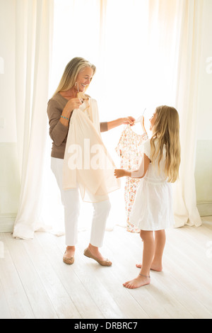 Nonna e nipote di abbigliamento di contenimento in corrispondenza della finestra Foto Stock