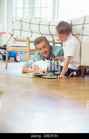 Padre e figlio della lettura in camera da letto Foto Stock