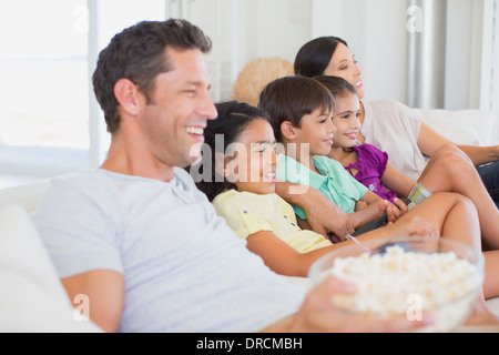 Famiglia di guardare la TV sul divano Foto Stock