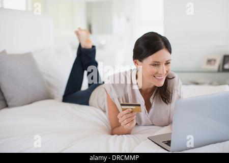 La donna lo shopping online con il computer portatile Foto Stock