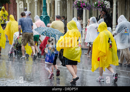 Famiglie indossano ponchos in caso di pioggia al Magic Kingdom di Walt Disney World, a Orlando, Florida. Foto Stock