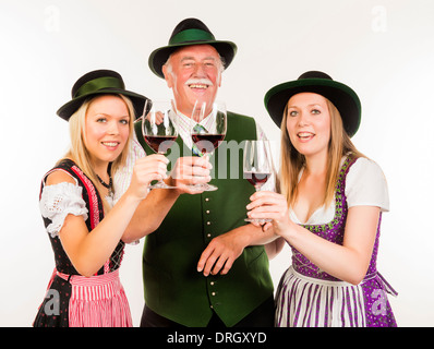 Senior und zwei junge Frauen in Tracht mit Weingläsern - la gente in costume tradizionale con bicchieri di vino Foto Stock