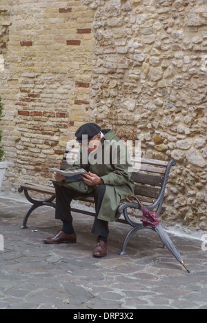 Uomo seduto sul banco la carta di lettura Italia Abruzzo Foto Stock