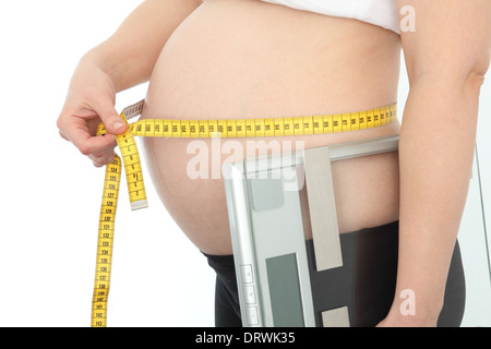 Gravidanza con nastro di misurazione e livello Foto Stock